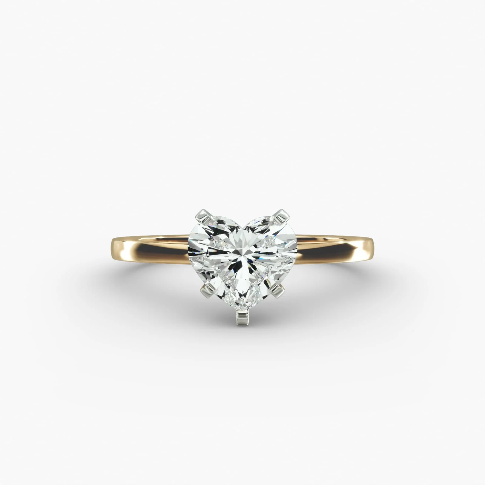 Gold ring with a heart-shaped diamond solitaire set in a four-prong setting.