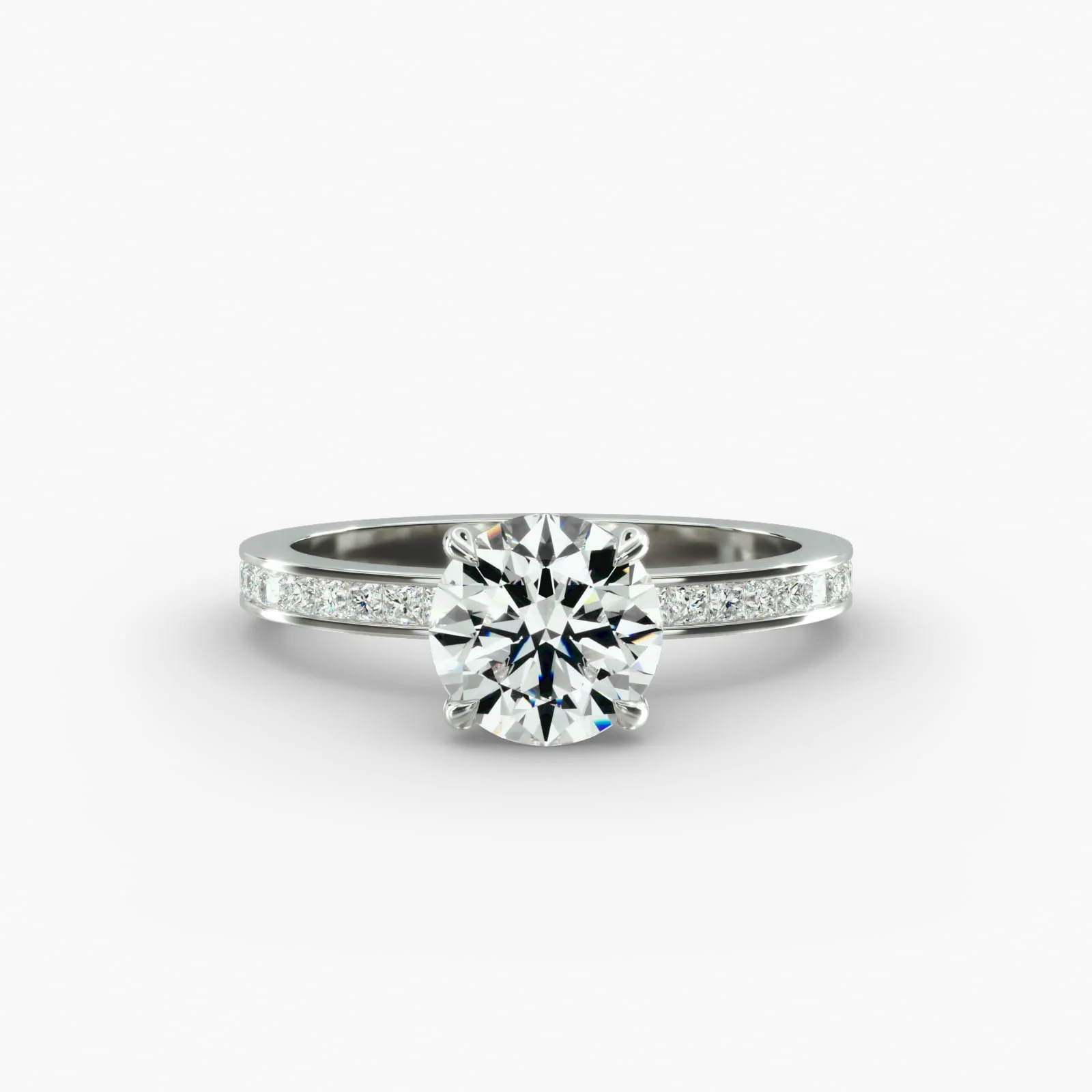 Close-up of a silver engagement ring with a large round diamond center stone and smaller diamonds on the band, set against a white background.