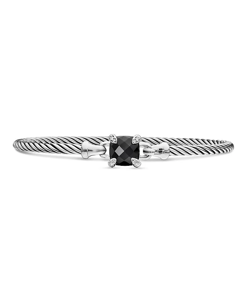 A silver twisted cable bracelet with a black gemstone in the center, flanked by small diamonds, on a white background.