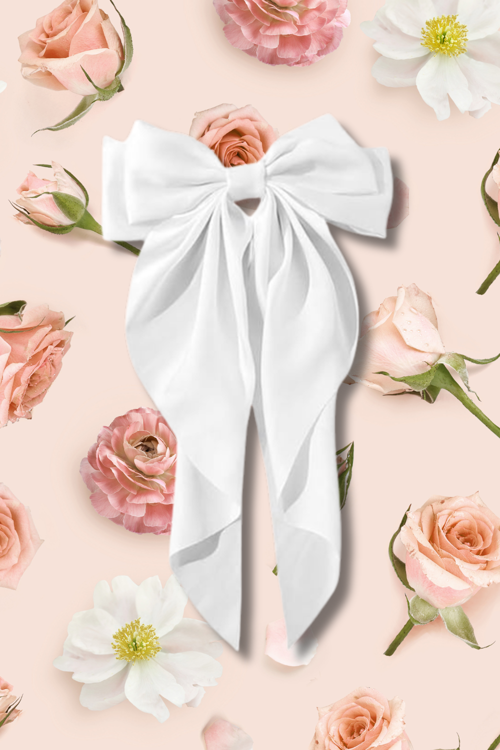 A white fabric bow with long tails placed on a light pink background, surrounded by pink and white roses and flowers.