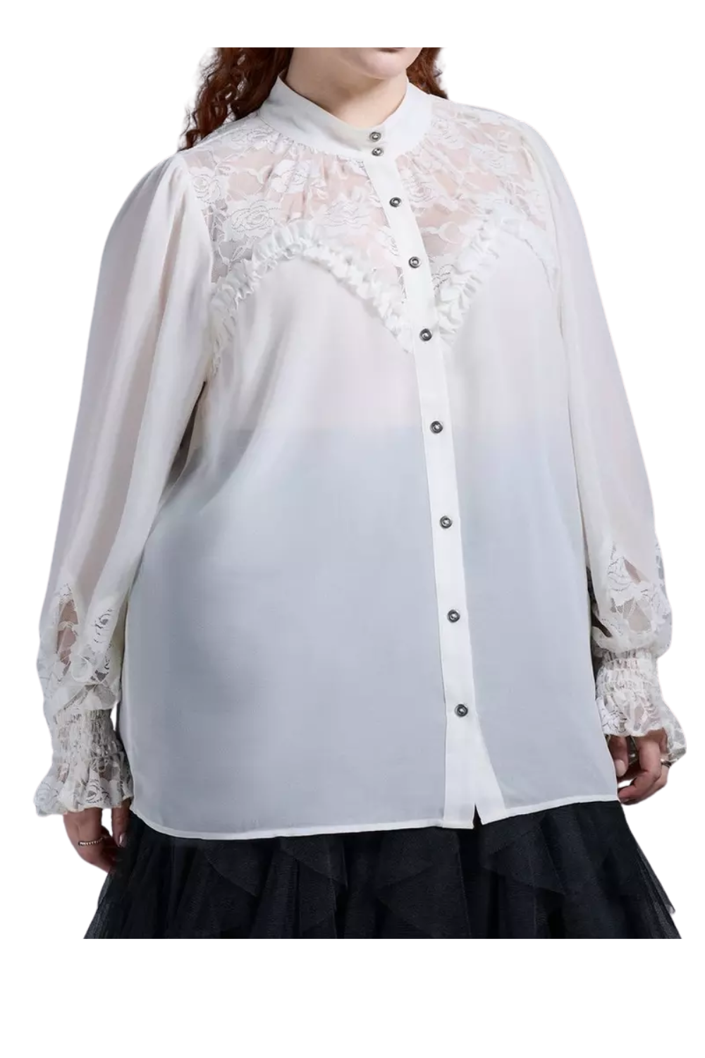 A woman wearing a white blouse with lace details on the shoulders and sleeves, buttoned down the front, with ruffled accents on the upper chest.