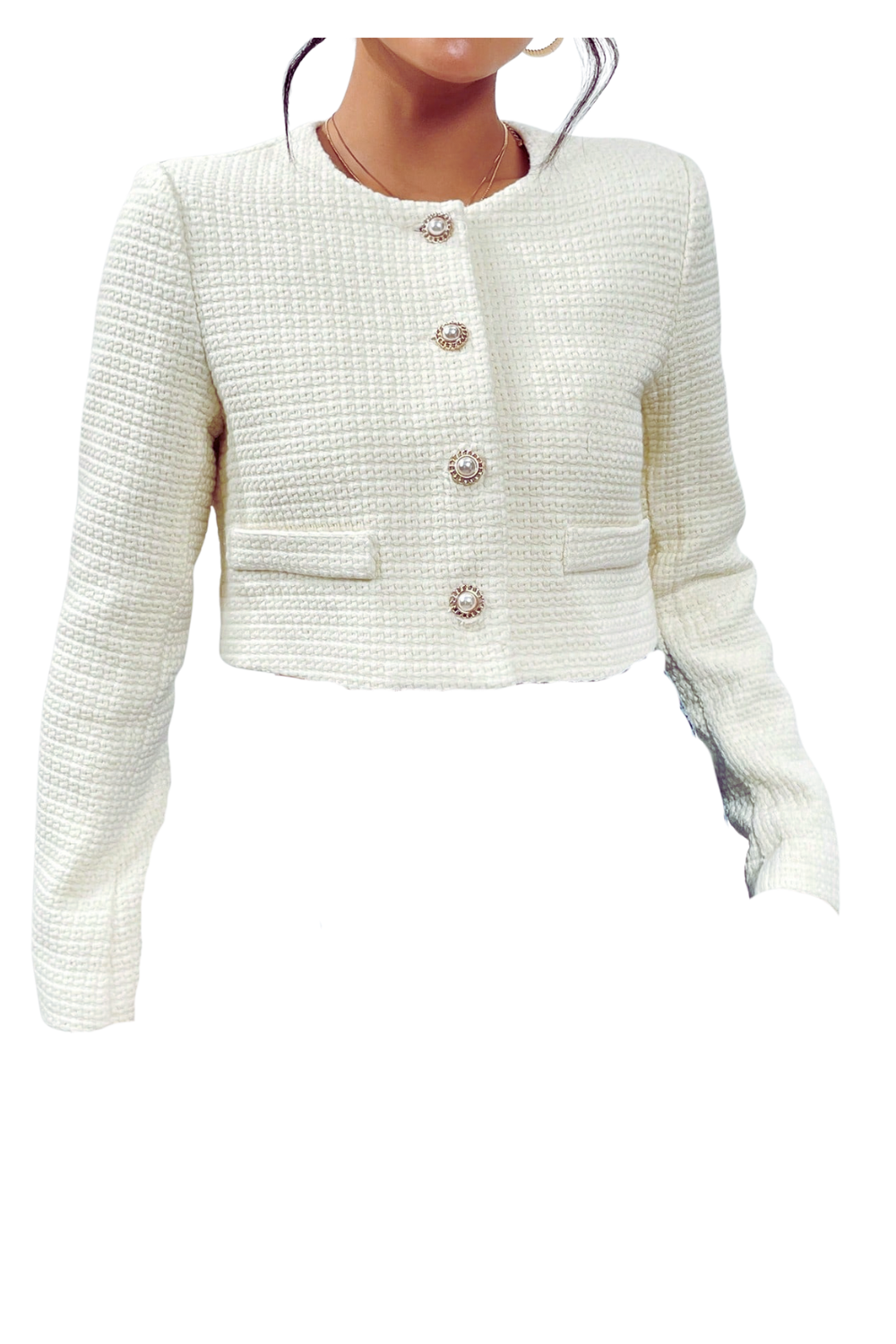 A woman wearing a white textured cropped blazer with pearl and gold buttons.