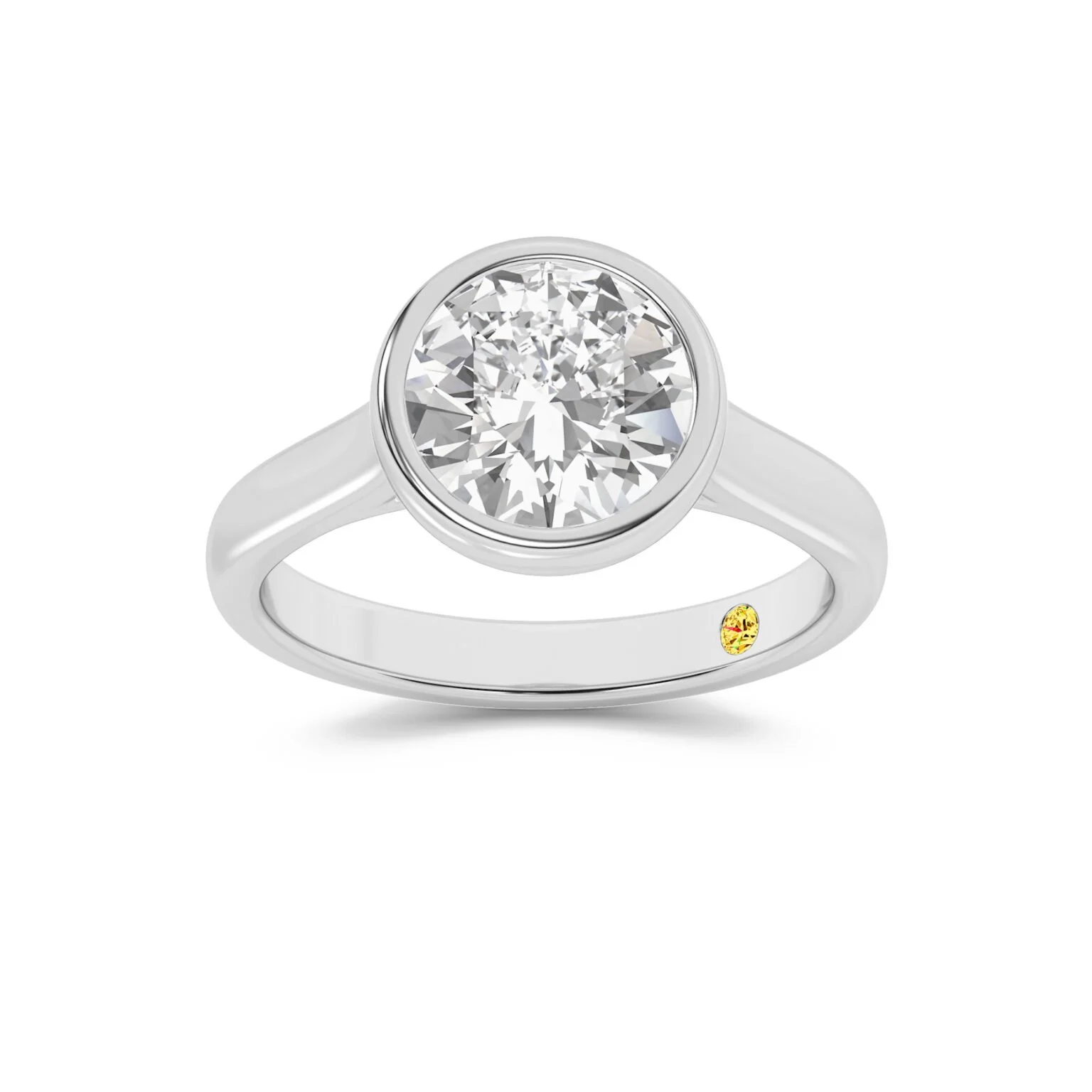 A silver ring with a central round diamond and a small yellow gemstone on the inner band.