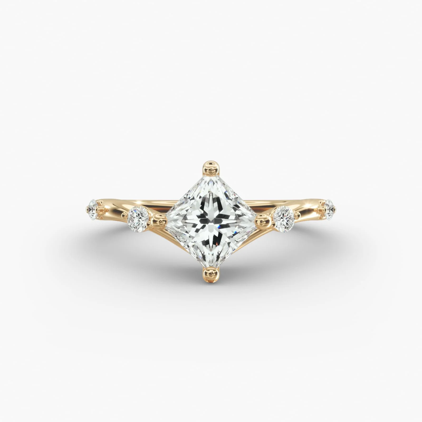 Gold ring with a large square diamond center and smaller diamonds on the band.