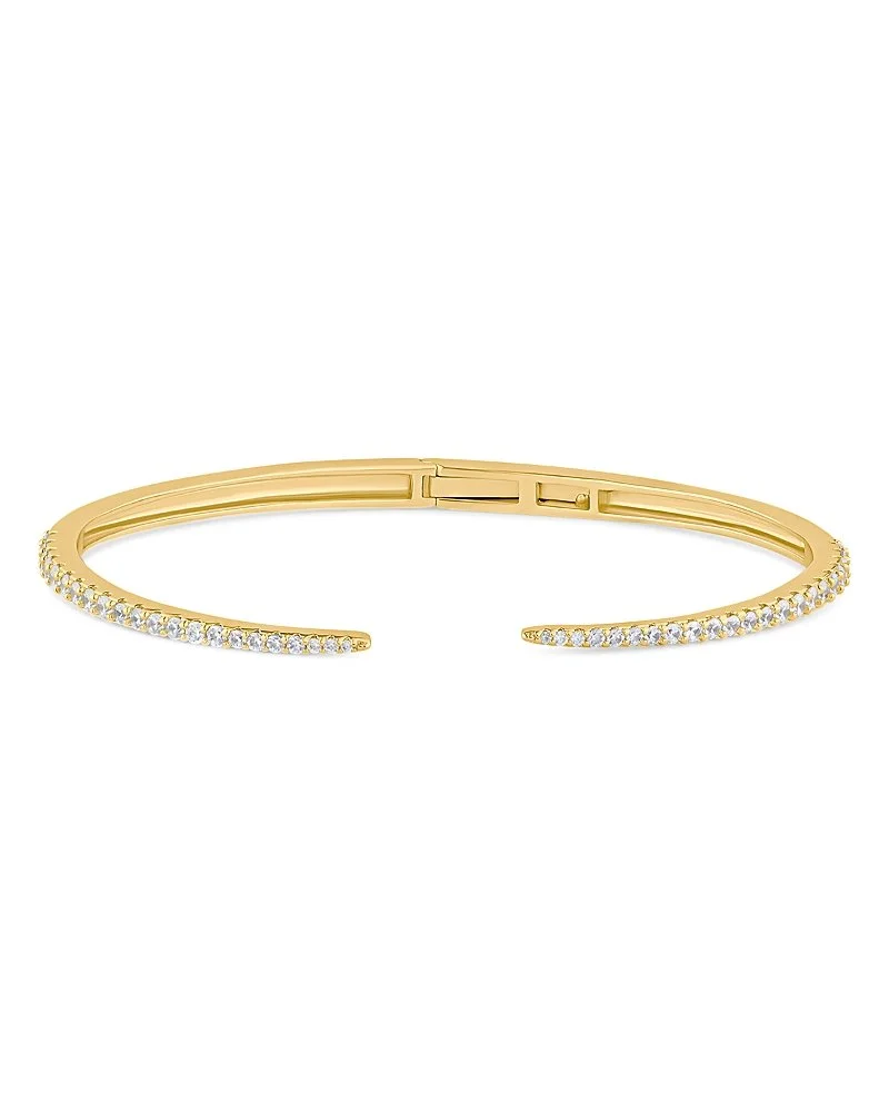 Gold open cuff bracelet with embedded small clear gemstones on the outer side.