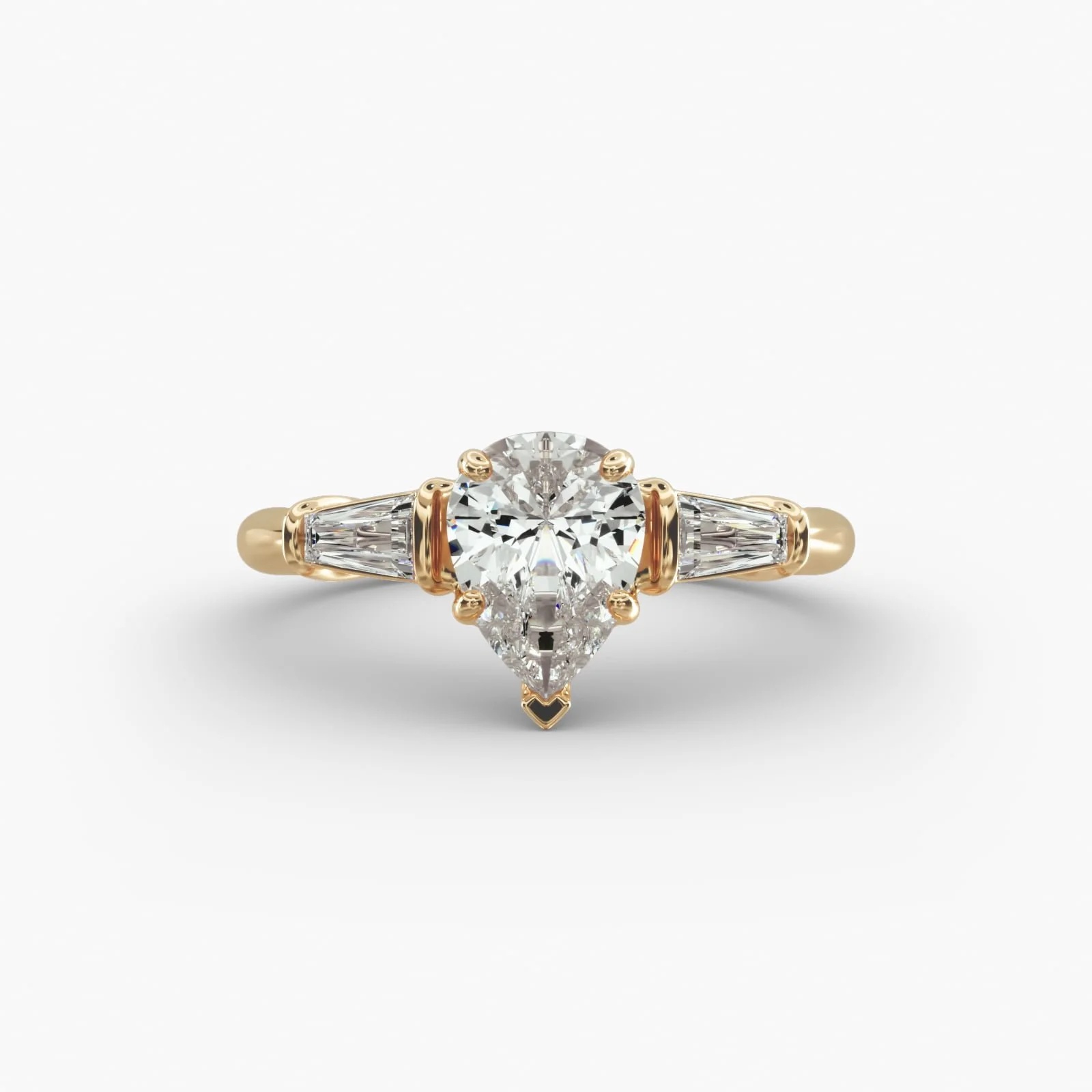 Diamond ring with a large round center diamond and two smaller tapered side diamonds set in a gold band.