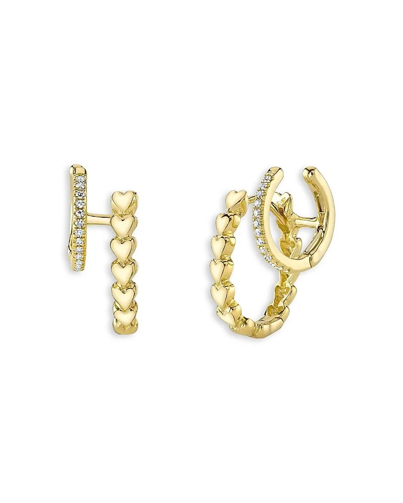 Pair of gold hoop earrings with heart-shaped details and embedded diamonds on a white background.
