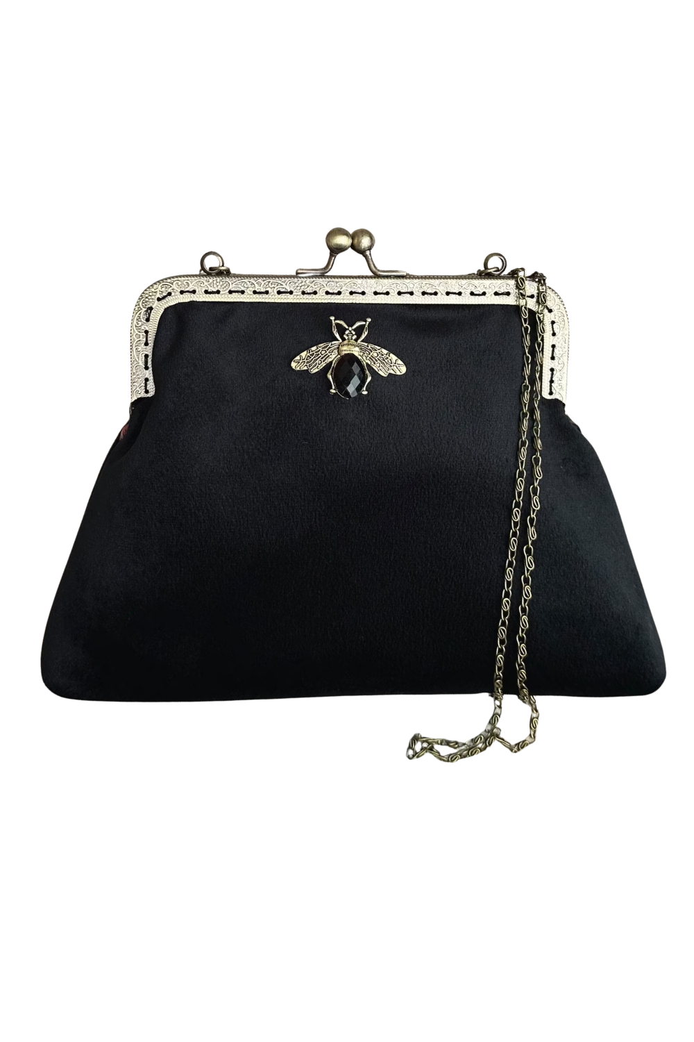 A black velvet vintage-style handbag with a metal bee ornament, a silver chain strap, and a clasp closure with a decorative frame.
