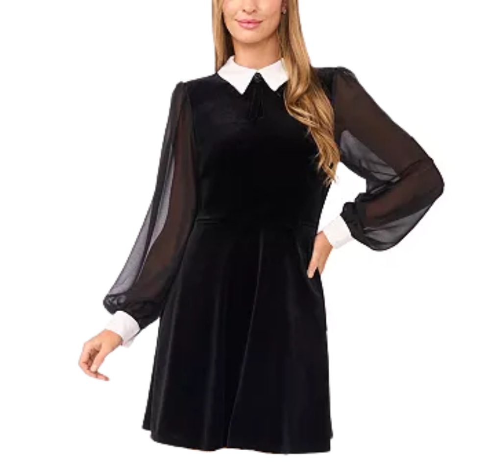 A woman wearing a black velvet dress with sheer black puffed sleeves and a white collar.