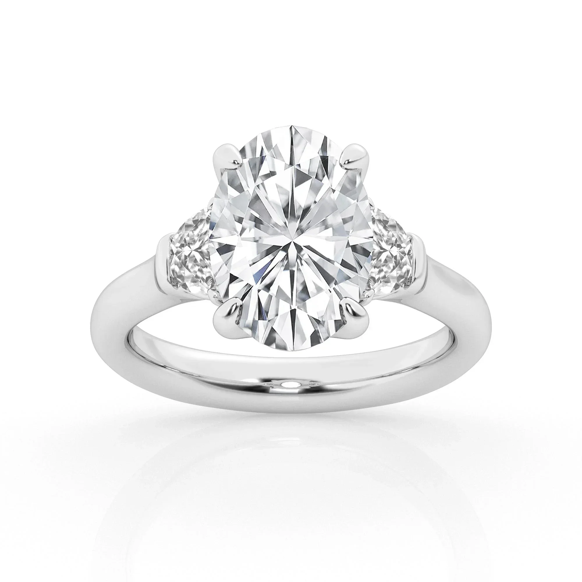 A silver engagement ring with a large oval diamond in the center and two smaller diamonds on each side.