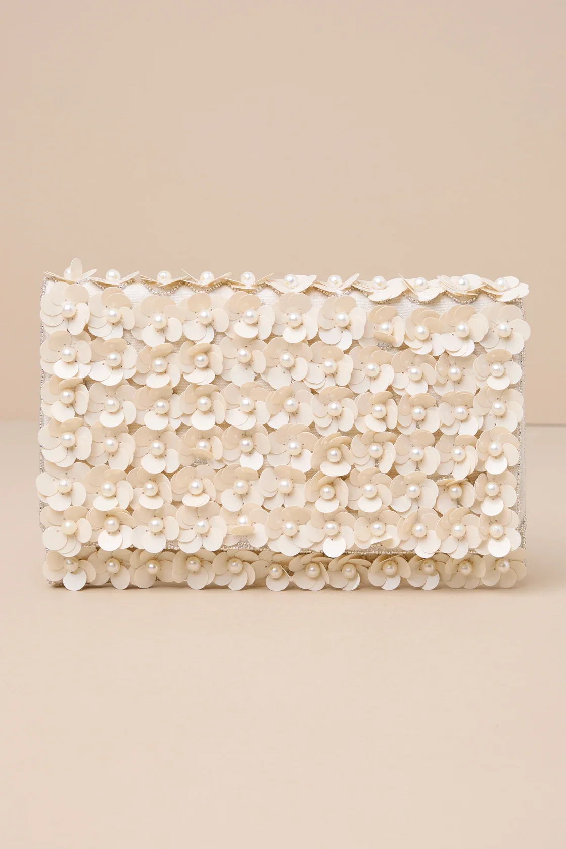 A white clutch purse decorated with small white flowers and pearls.