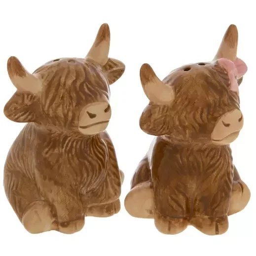 Pair of ceramic cow figurines with a brown and tan striped pattern, one with a pink bow on its head.