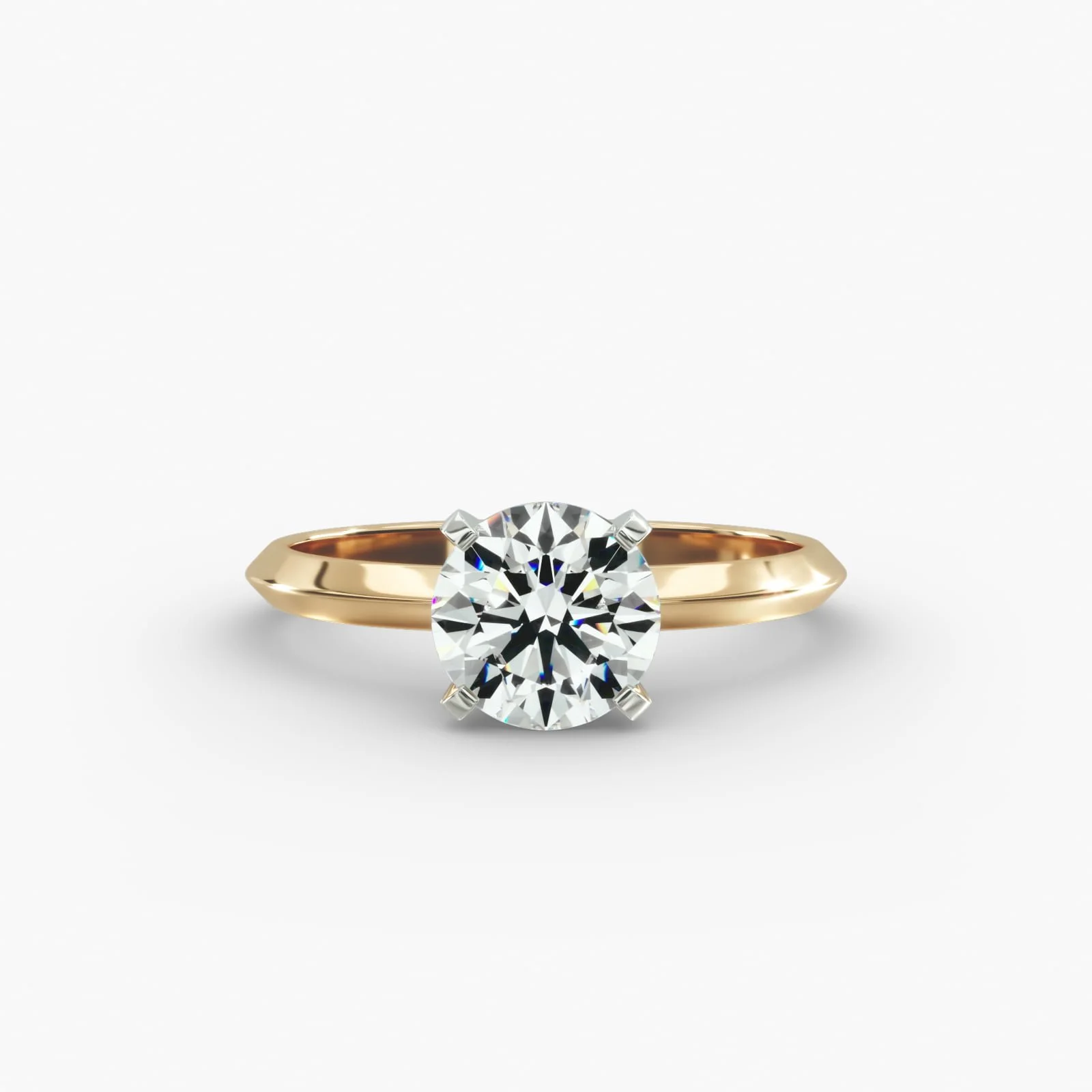 Gold engagement ring with a large round diamond solitaire gemstone on a white background.