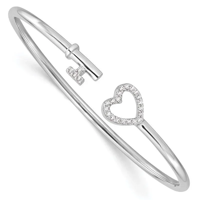 Silver bracelet with a heart and cross charms, adorned with small diamonds.