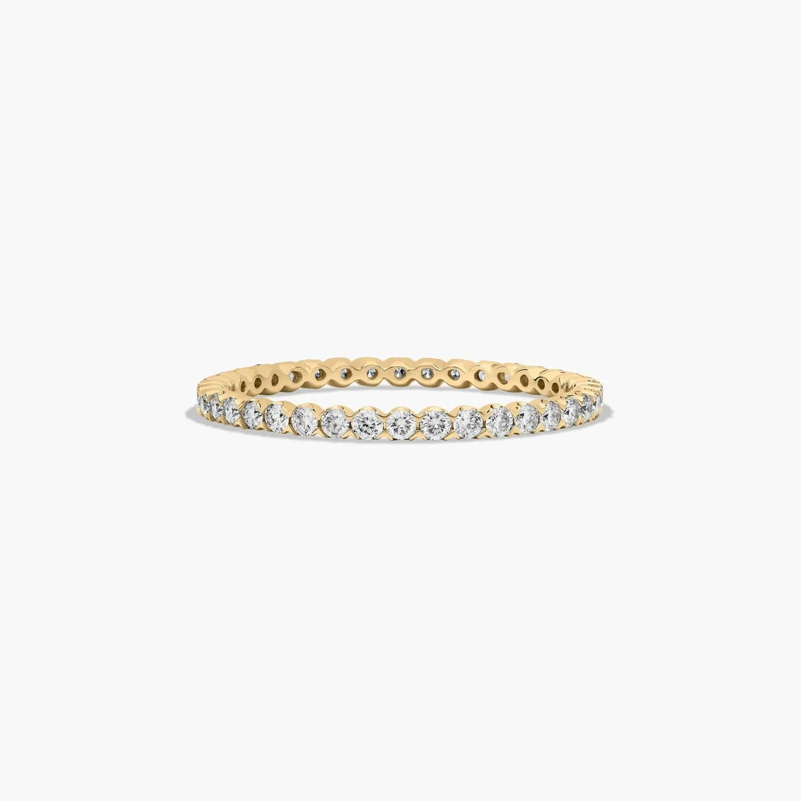 Gold ring with a row of round diamonds set around the band.