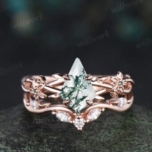 Close-up of a gold ring with a triangular stone and floral accents
