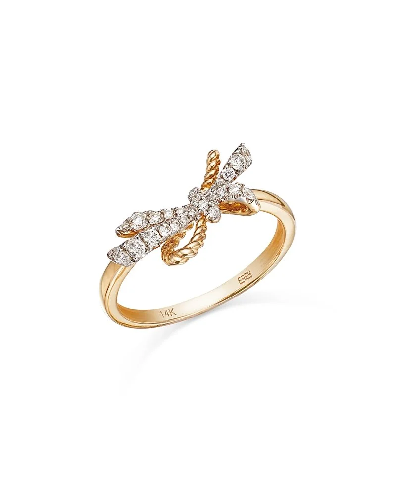 Gold ring with a bow-shaped design adorned with small diamonds.
