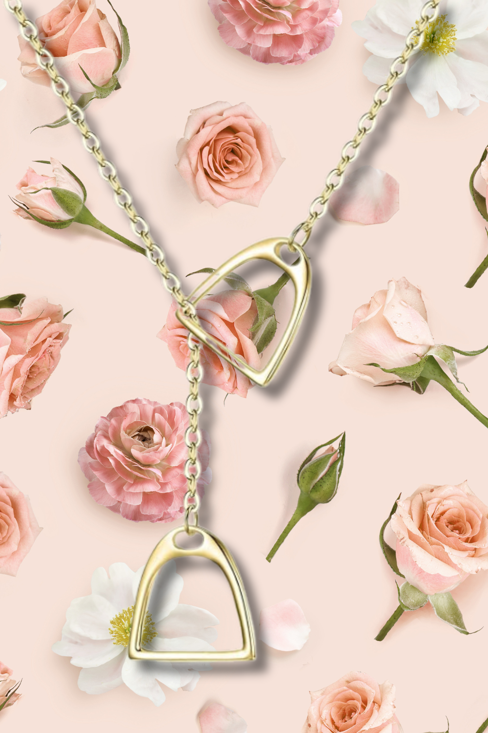 A gold heart-shaped necklace chained over a background of pink and white roses and flower petals.