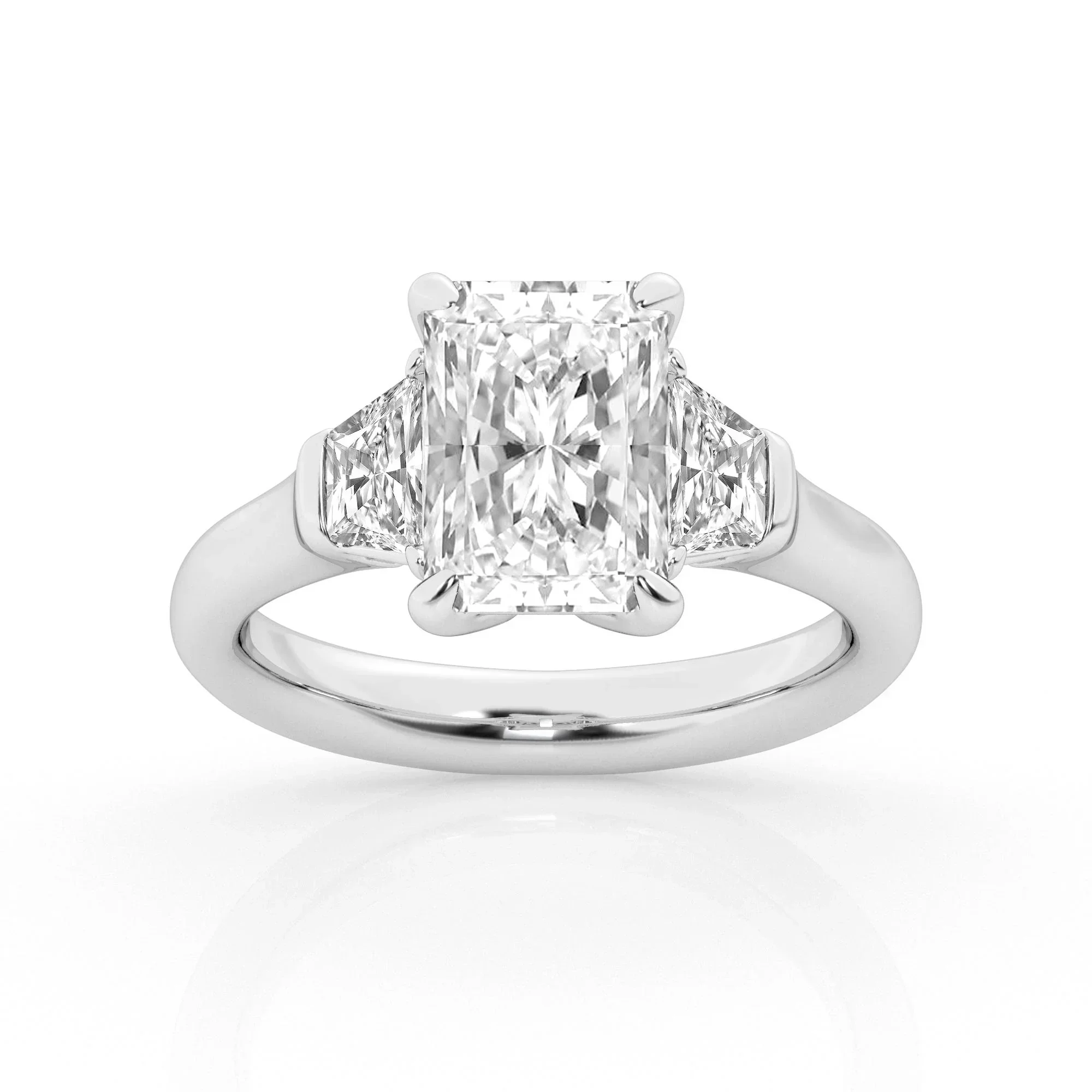 A silver engagement ring with a large rectangular diamond center stone flanked by two smaller triangular diamonds.