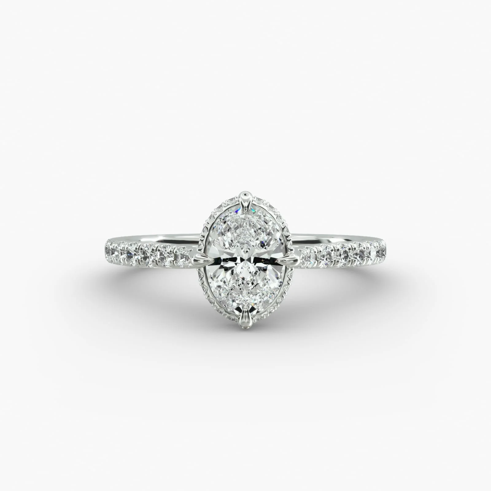 Silver ring with an oval-shaped cluster of diamonds at the center, set on a white background.