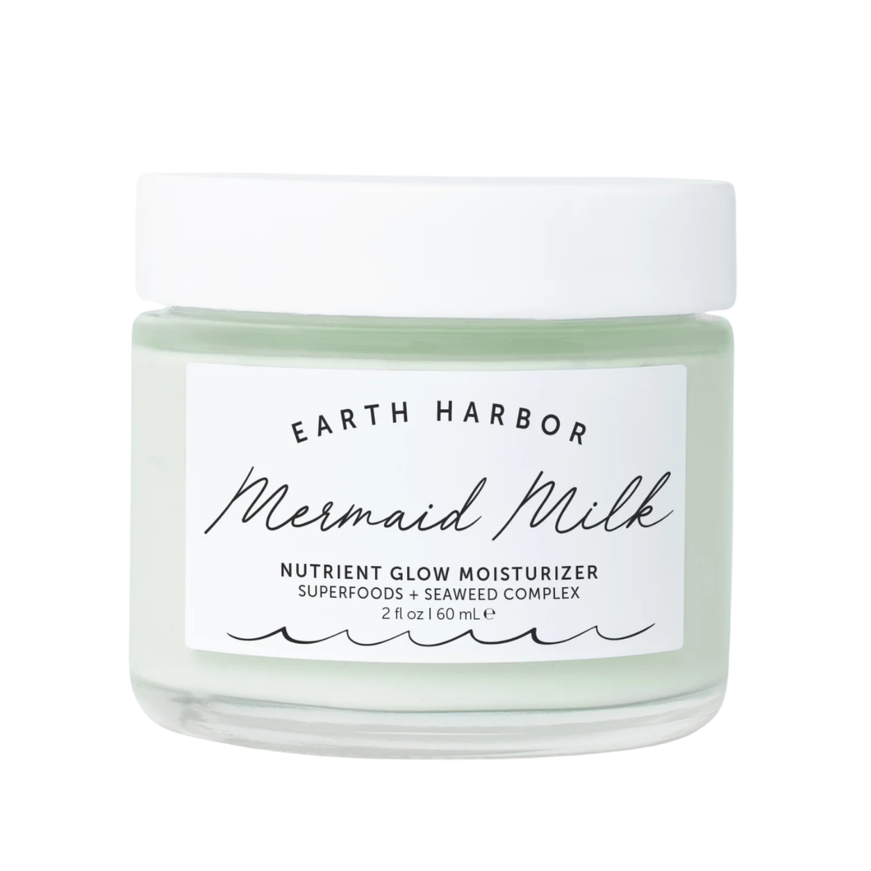 A jar of Earth Harbor Mermaid Milk nutrient glow moisturizer with a white lid and a label featuring black text and wave designs.