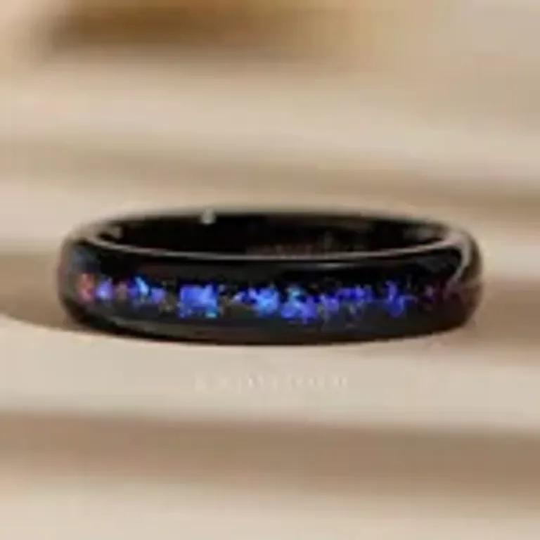 Close-up of a black ring with a blue flame design inside.
