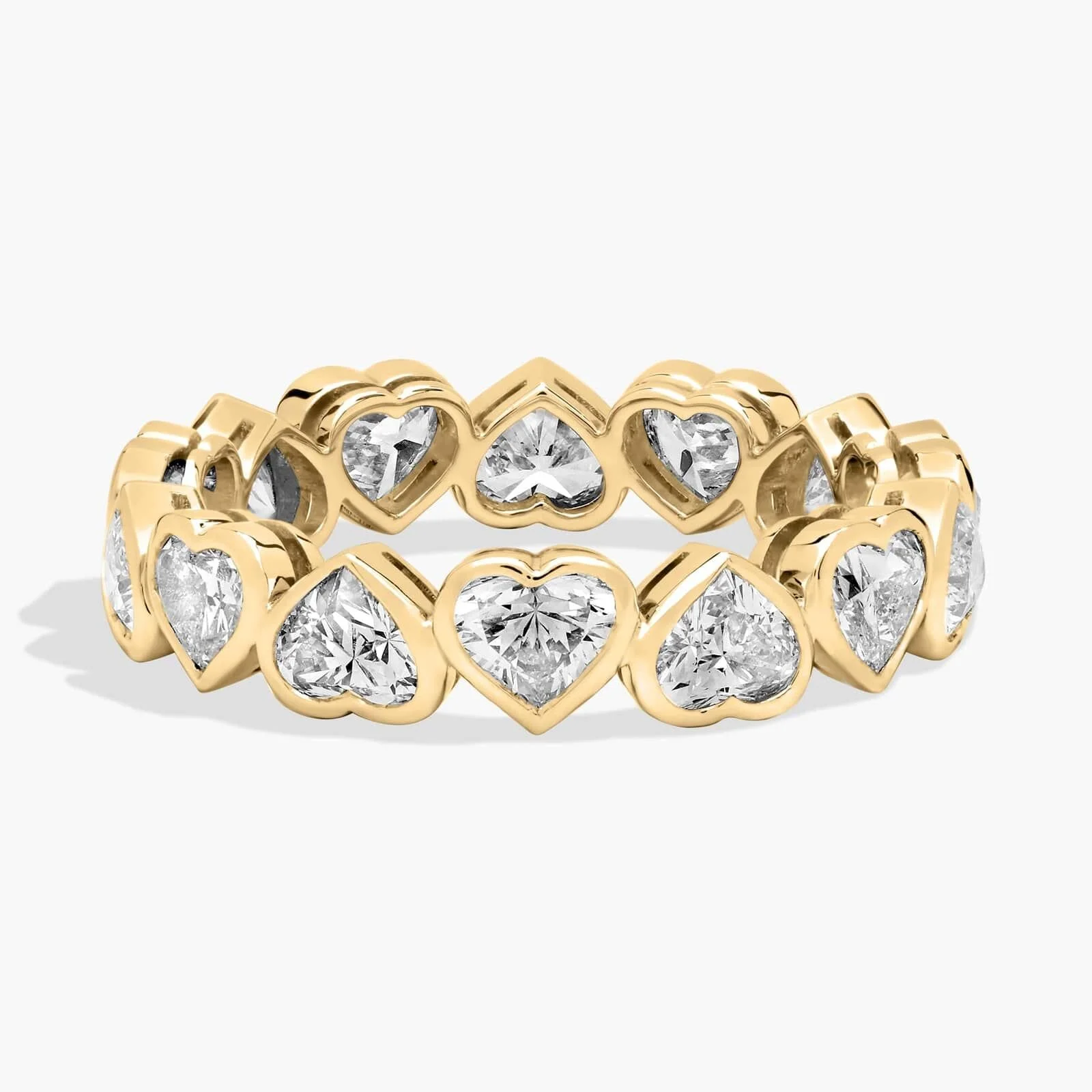Gold ring with heart-shaped diamonds set in gold in a continuous pattern.