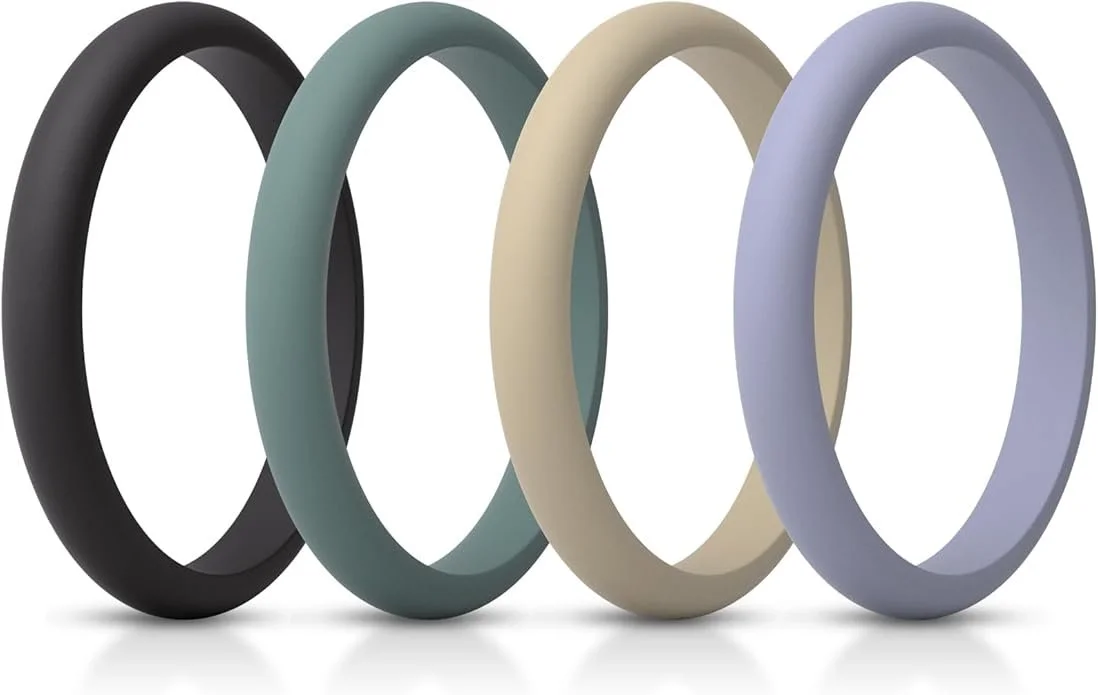 Four silicone bracelets in black, green, beige, and purple colors arranged in a row. alternative engagement rings, finger safe engagement rings, replacement ring