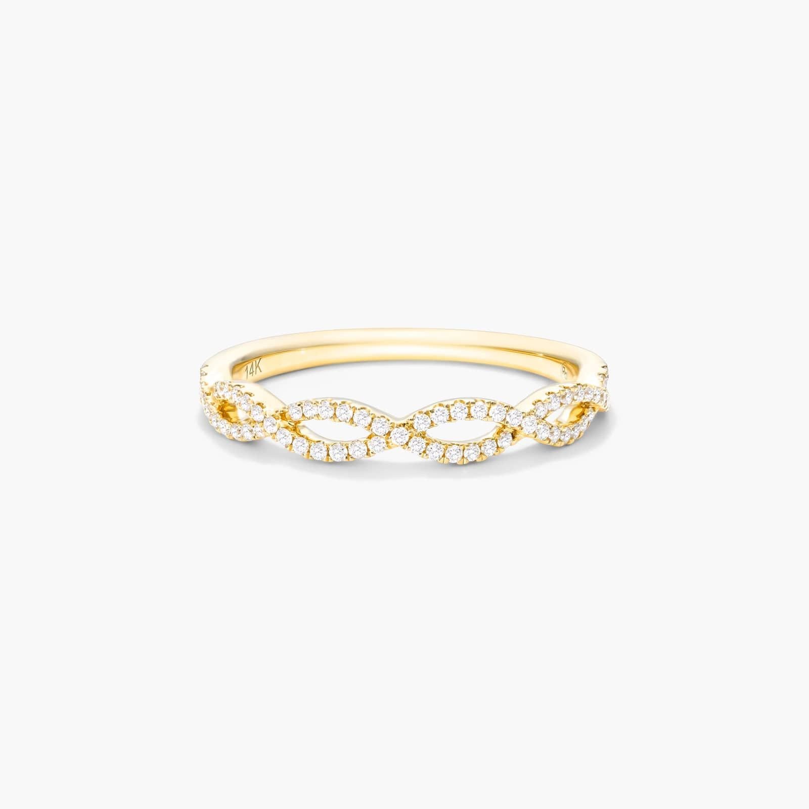 Gold ring with a double infinity design encrusted with small diamonds.