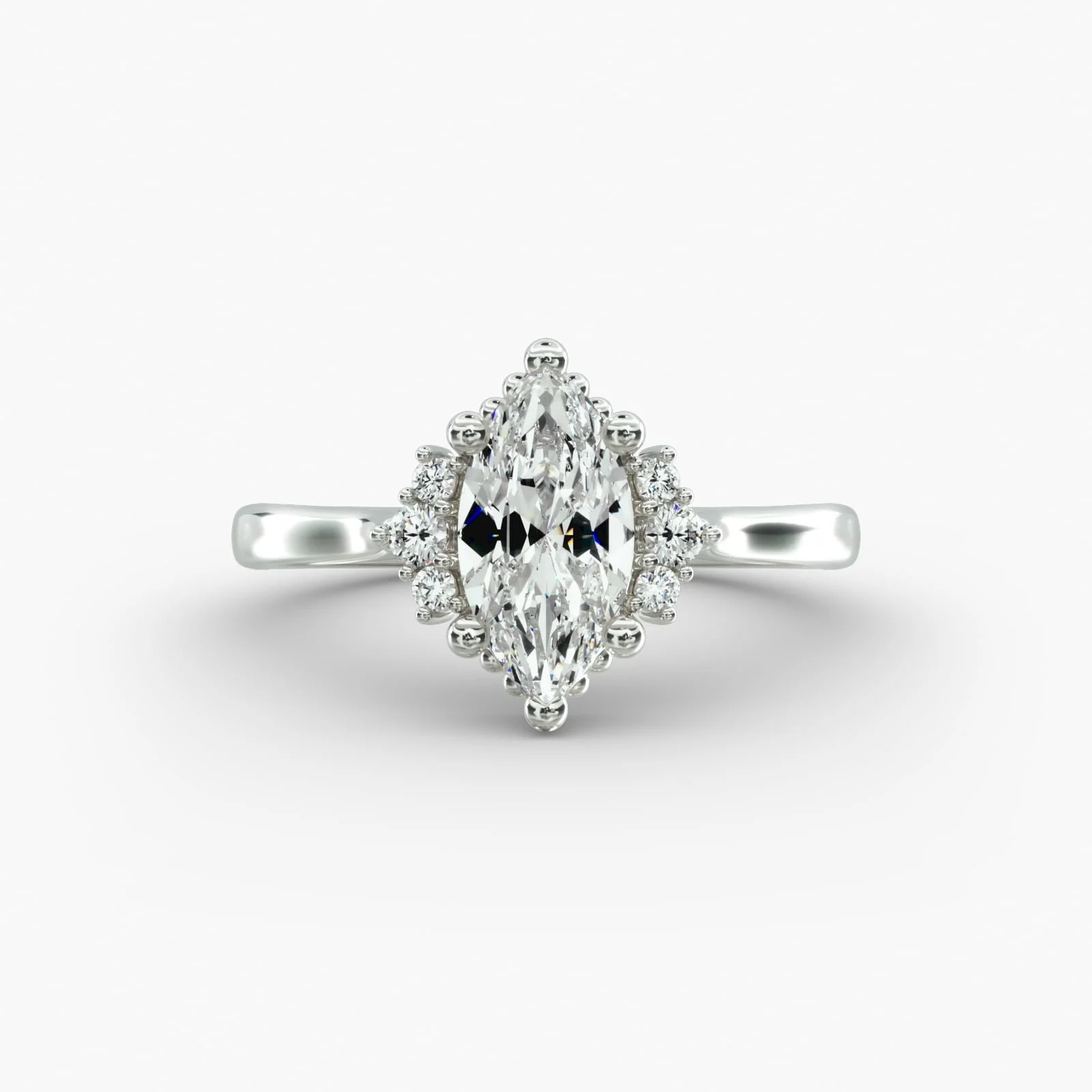 A silver ring with a marquise-shaped diamond center surrounded by smaller diamonds on a white background.