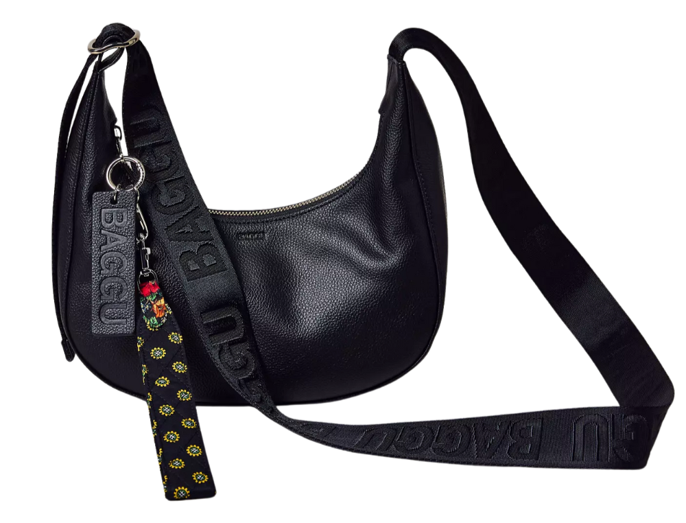 Black leather shoulder bag with an adjustable strap, keychain with a black tag that says "BAGGU" and a hanging fabric tag with a floral pattern.