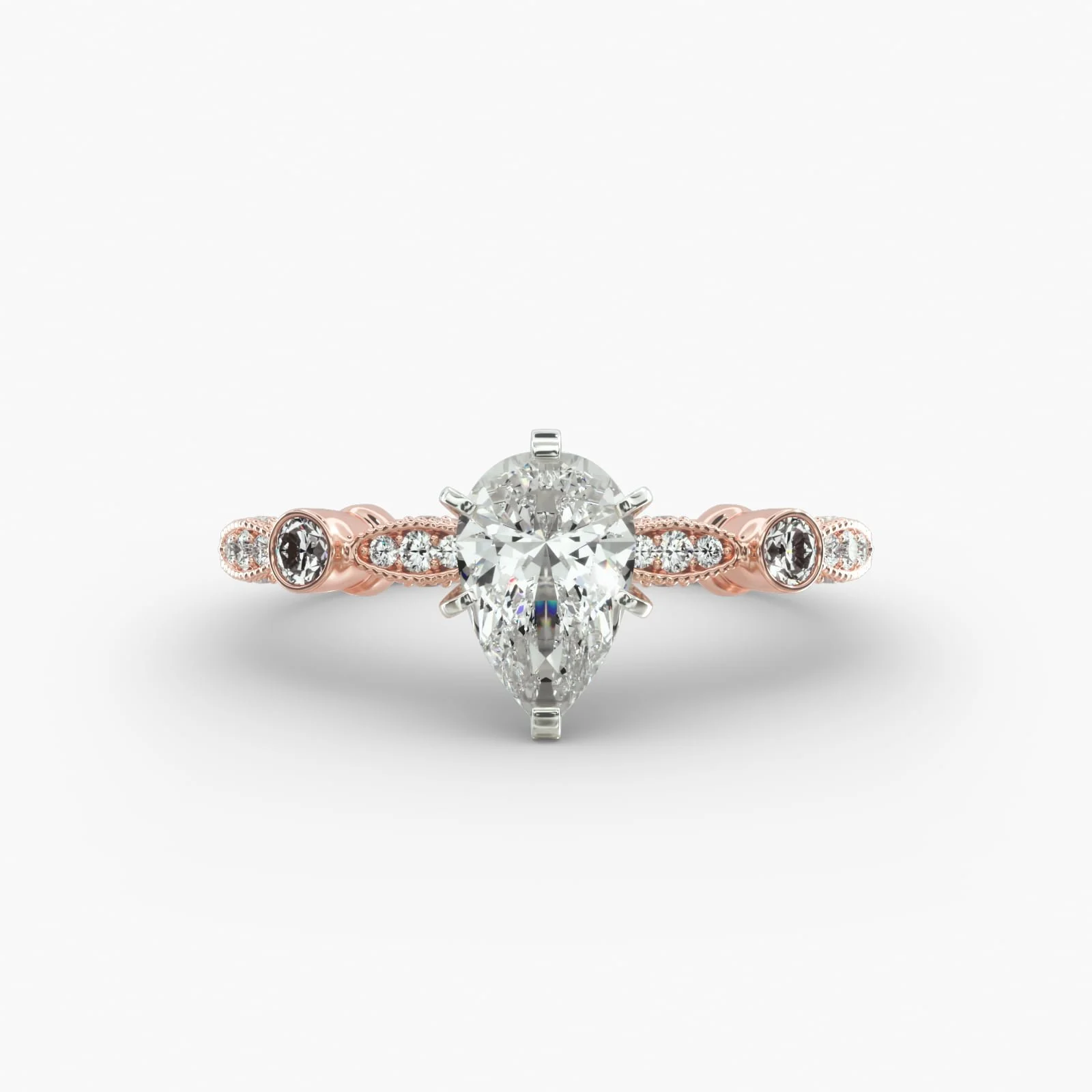 A close-up of a diamond engagement ring with a pear-shaped center diamond set in a white gold or platinum band, accented with smaller round diamonds along the band.