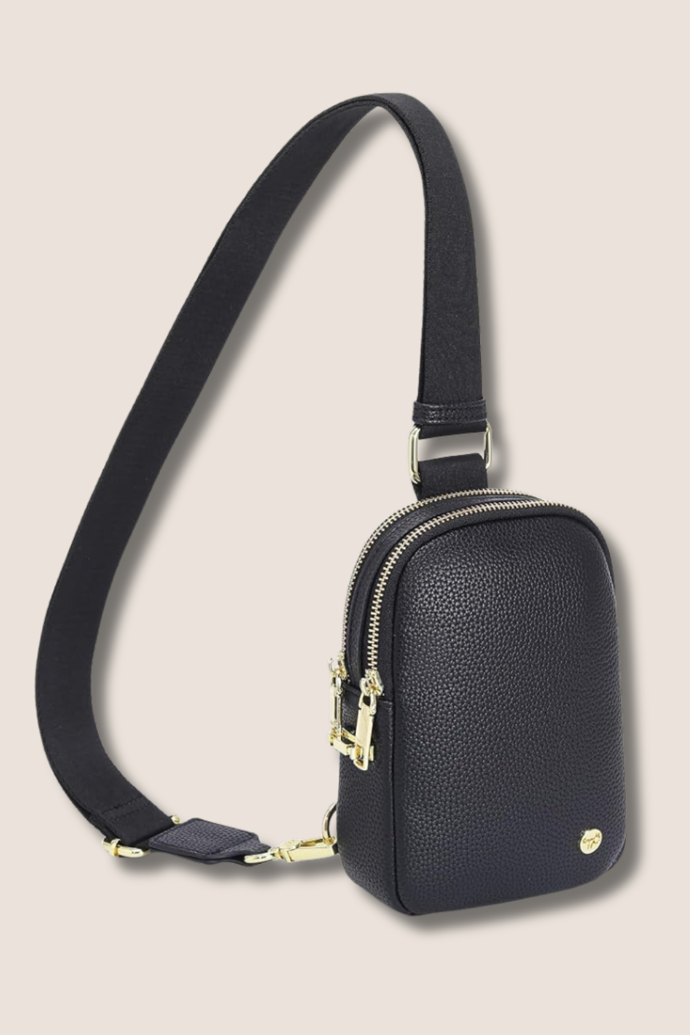 Black textured crossbody bag with gold zippers and hardware, featuring a wide adjustable strap on a light background.