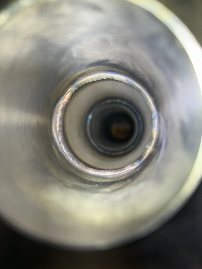 Close-up view of the inside of a metallic cylindrical object, showing concentric circles.