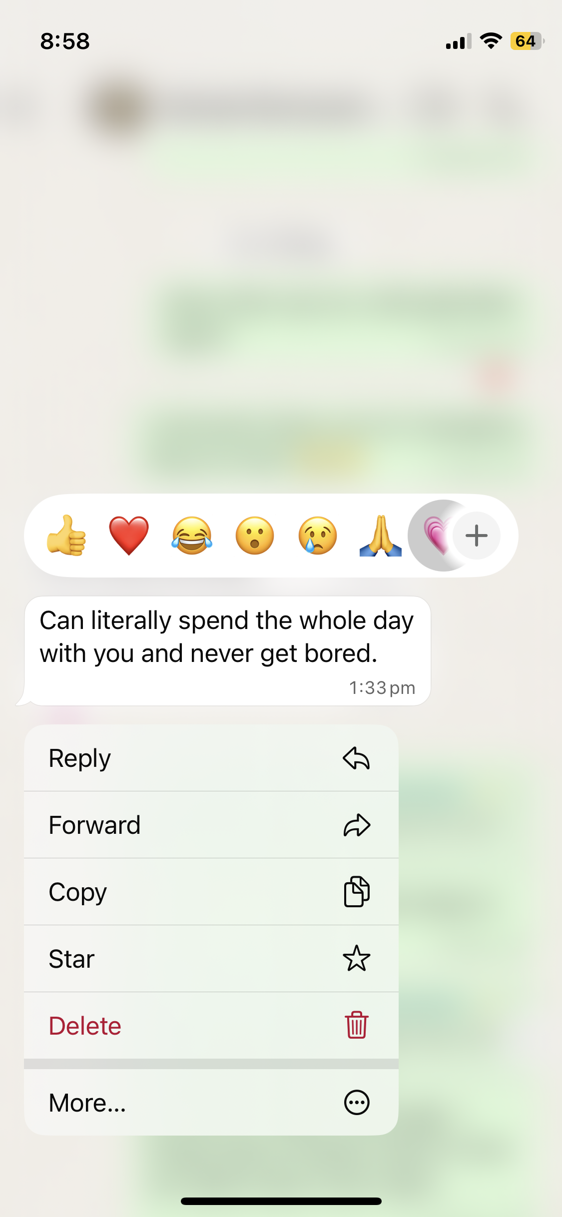 A screenshot of a messaging app showing a conversation with a message saying, "Can literally spend the whole day with you and never get bored," sent at 1:33 PM. The message is accompanied by a reactions bar with various emojis including thumbs up, heart, laughing, surprised, crying, prayer hands, and a pink heart. A menu is open below the message with options like reply, forward, copy, star, delete, and more.