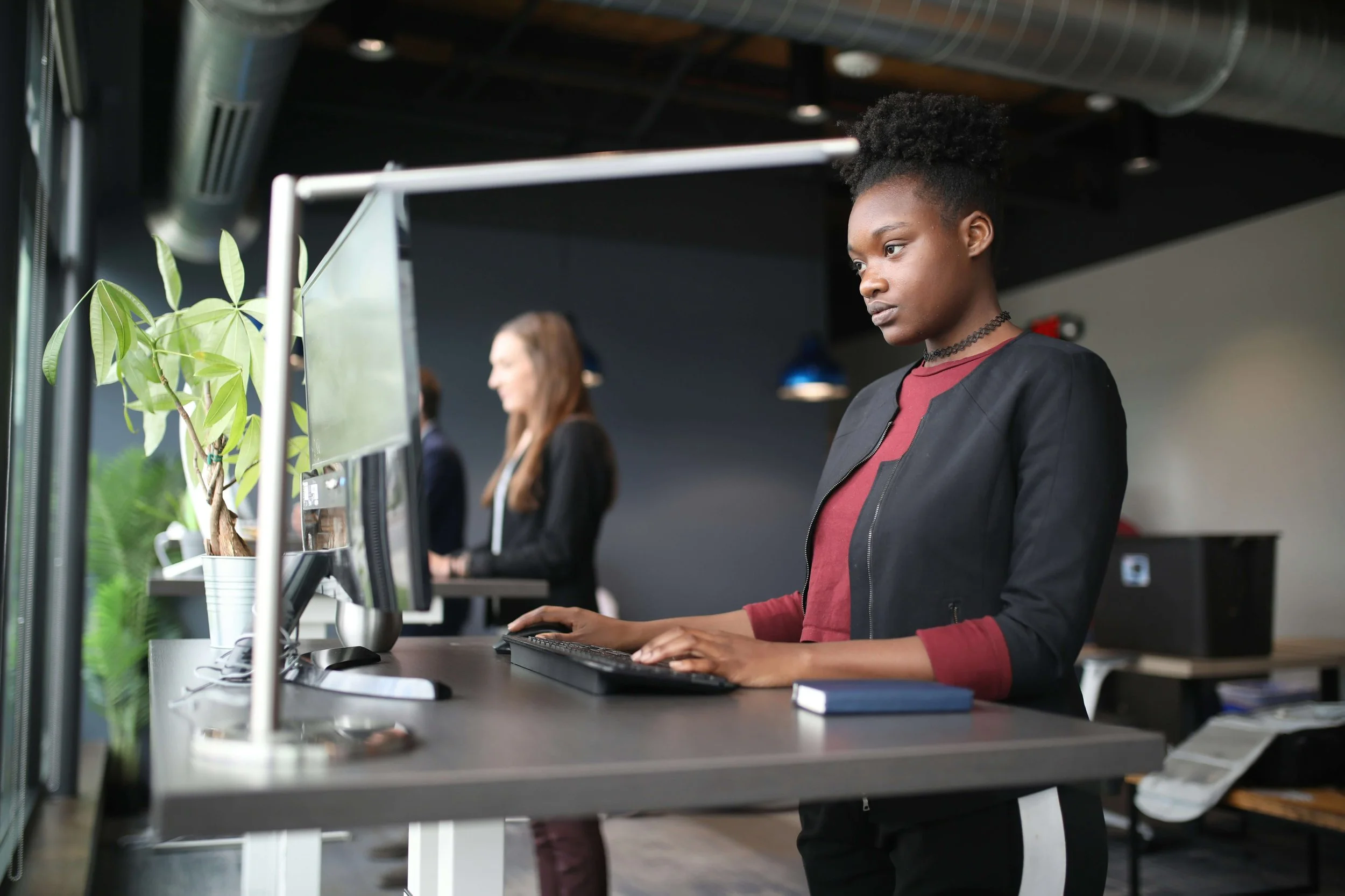 women working on standing desks at a startup