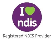 A circular logo with a purple background, green heart, and white text reading 'I ❤️ NDIS' and below it 'Registered NDIS Provider'.