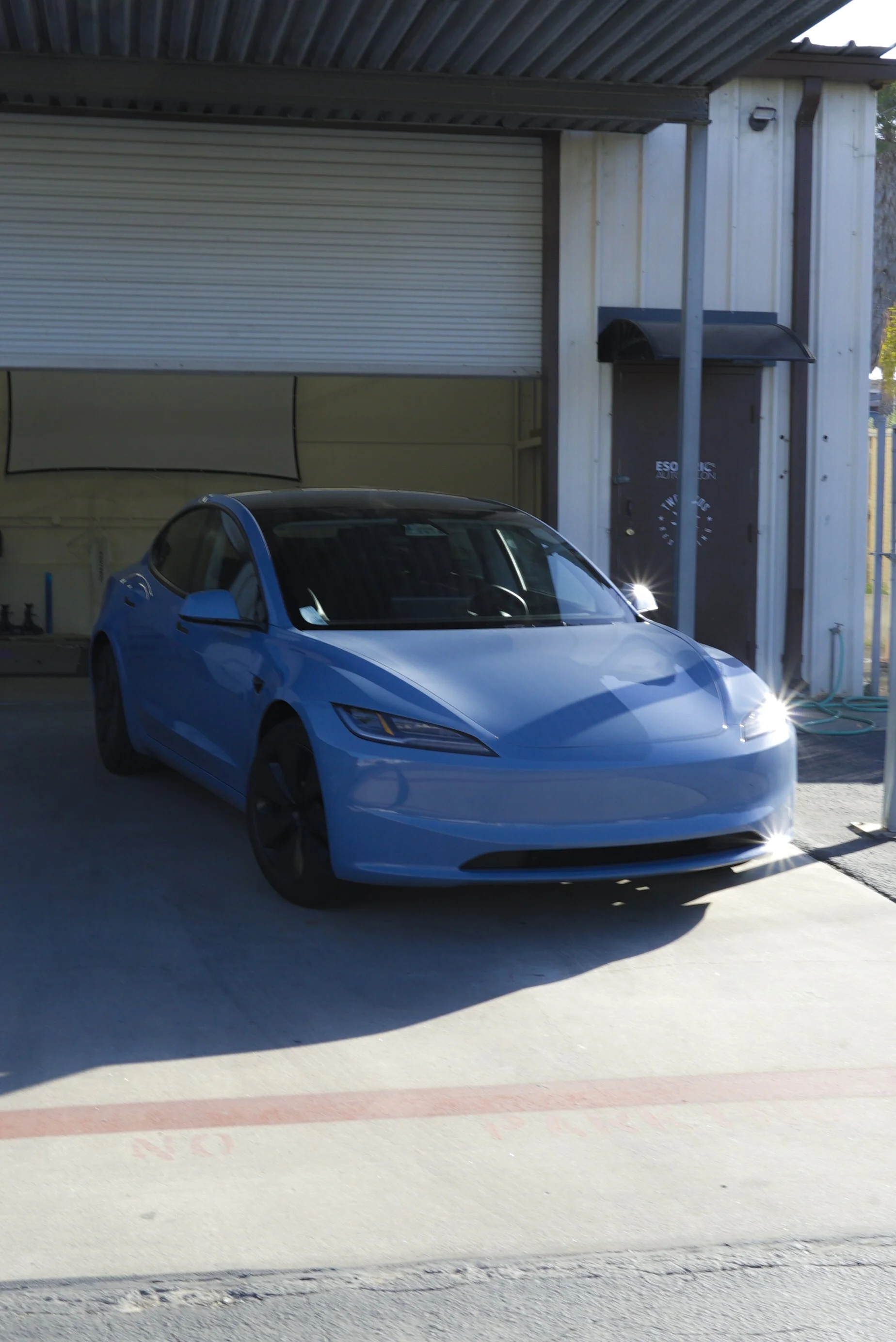 Tesla is wrapped in colored paint protection film blue colored PPF