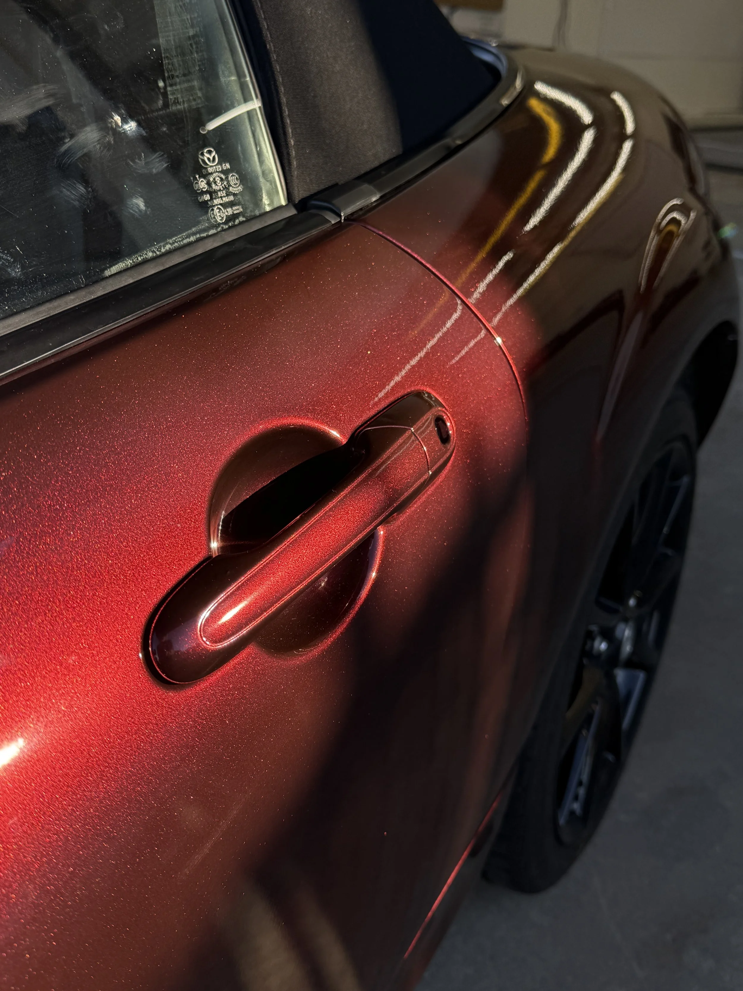 Miata club wrapped in black red iridescent vinyl wrap