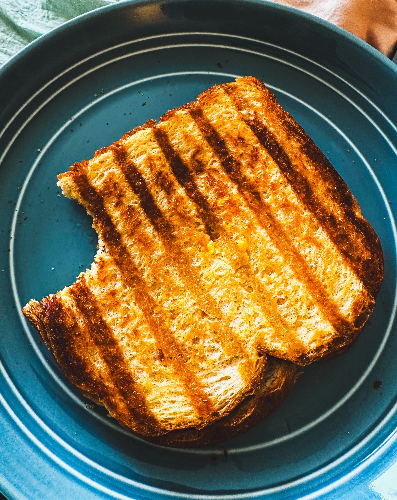 Grilled cheese sandwich on blue plate
