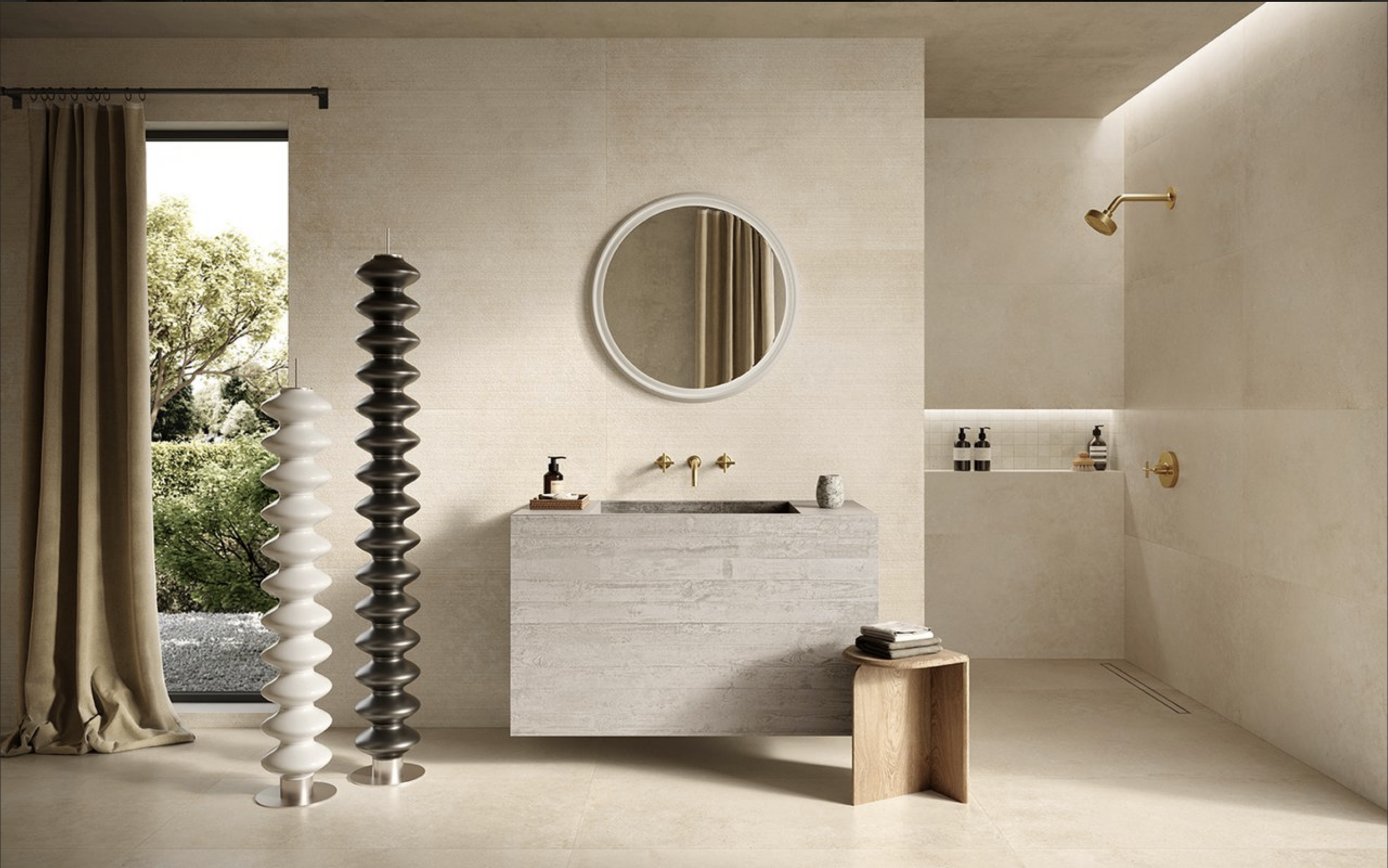 Modern beige bathroom with a round mirror above a stone vanity, a rain shower head, and decorative hanging sculptures.
