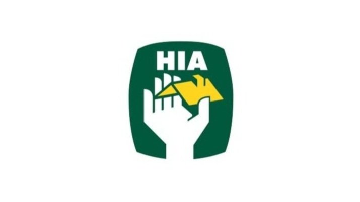 A logo featuring a green shield with the white text 'HIA', a white hand holding a yellow house, and a yellow roof silhouette.