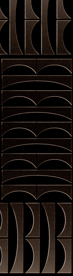 Close-up of black wooden panels with geometric cut-out patterns, including circular and curved shapes.