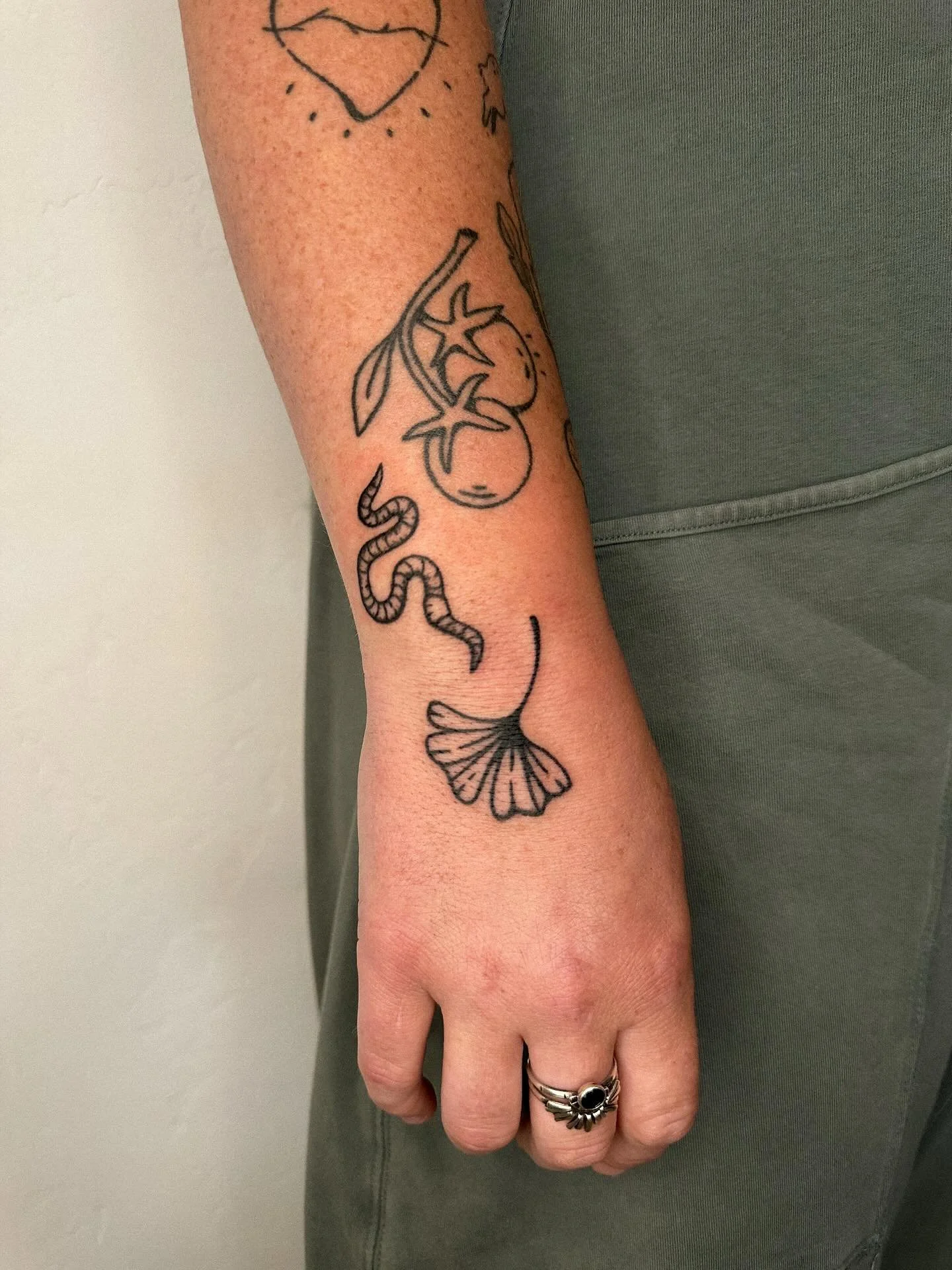 handpoked worm &amp; ginkgo leaf! next to a few other healed pieces for Chelsia🪱💚