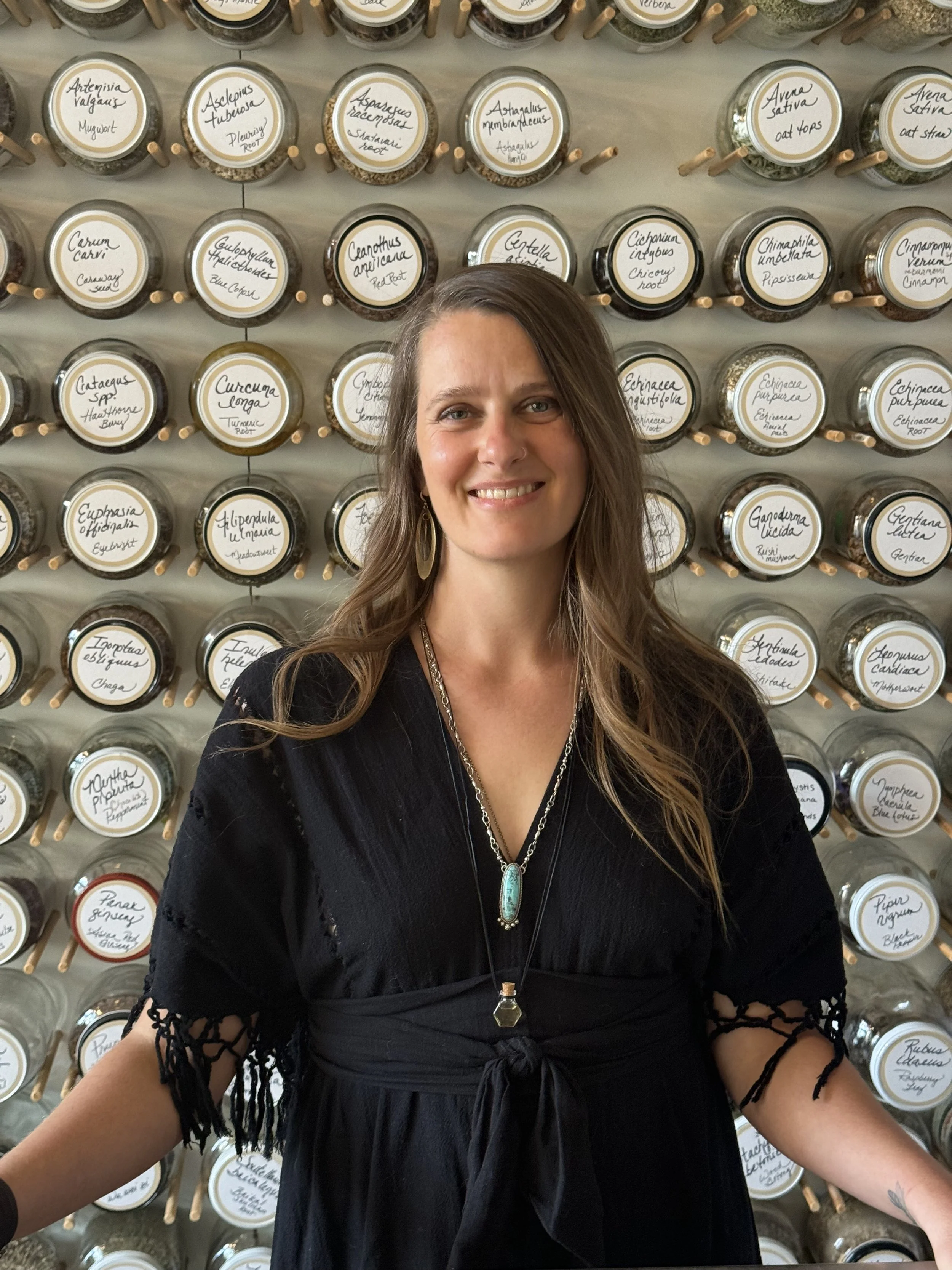 me (Amy) standing in front of an herbal apothecary