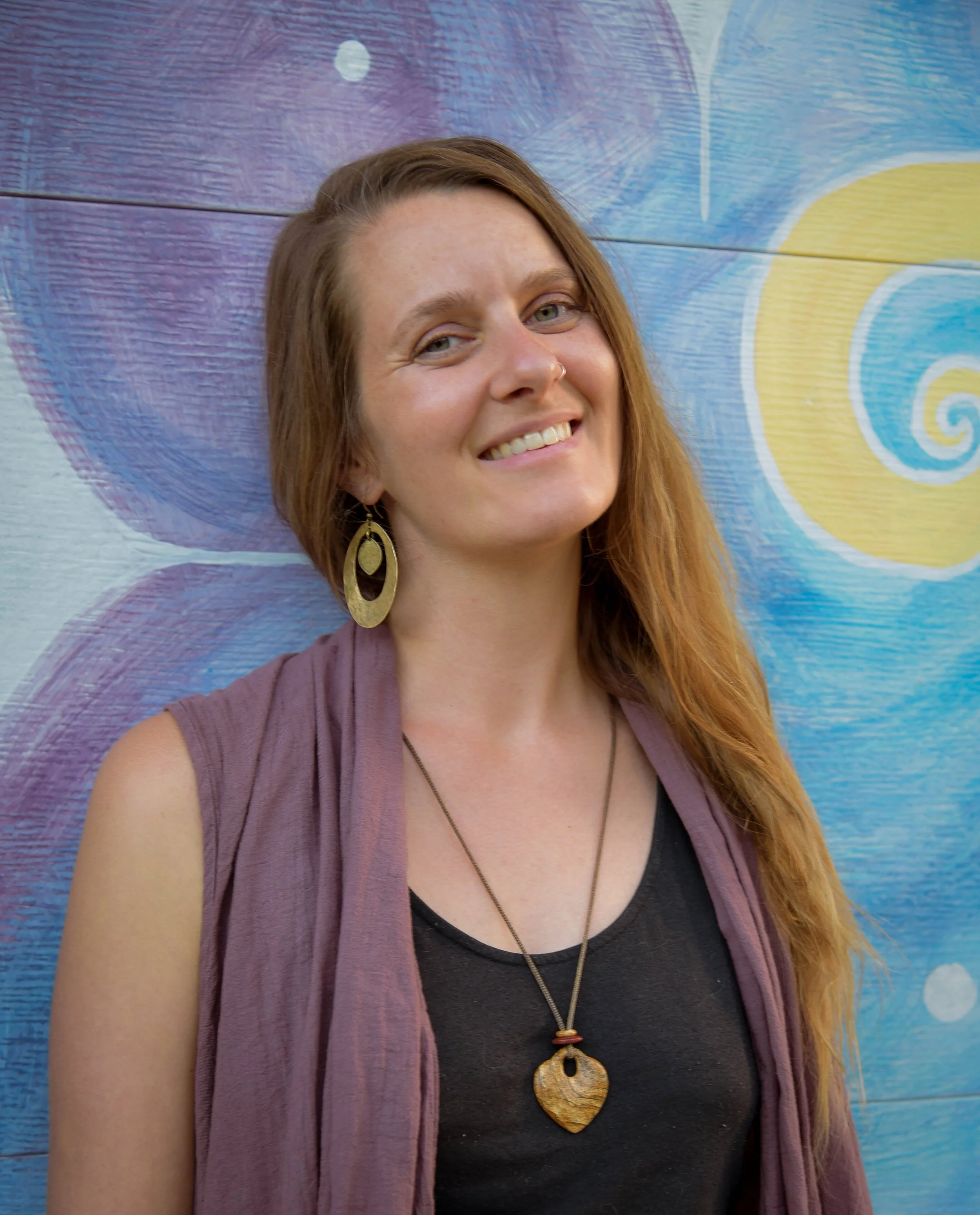 Amy Leithliter in front of a colorful mural
