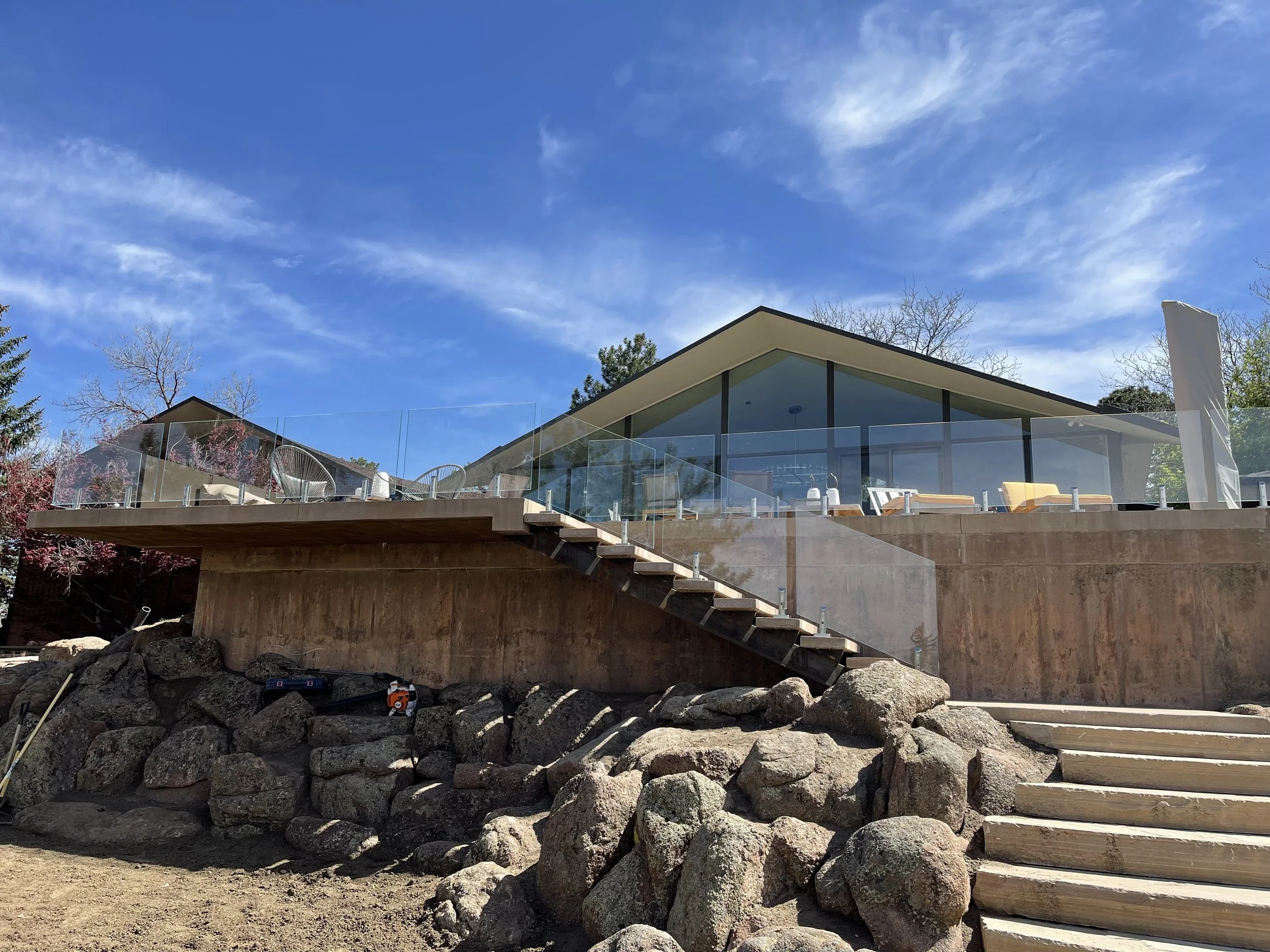 Exterior glass deck railing installation in Colorado