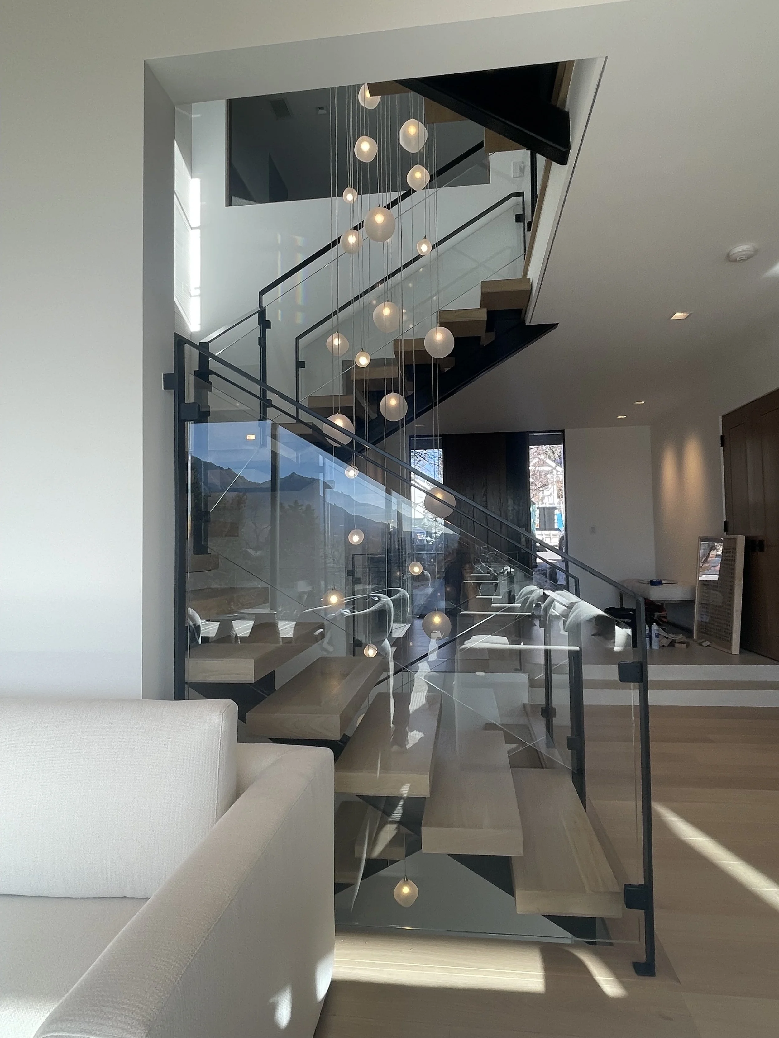 Modern interior with staircase and pendant lighting.