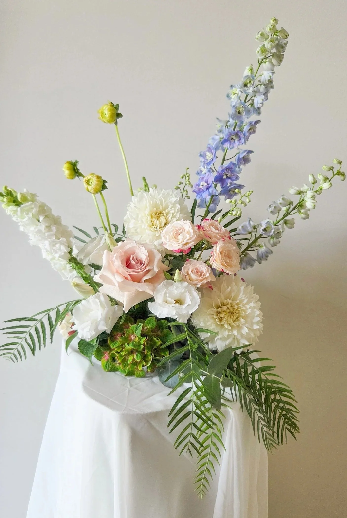 mini cloud table arrangement, dahlias, roses, delphinium snapdragons and hydrangea