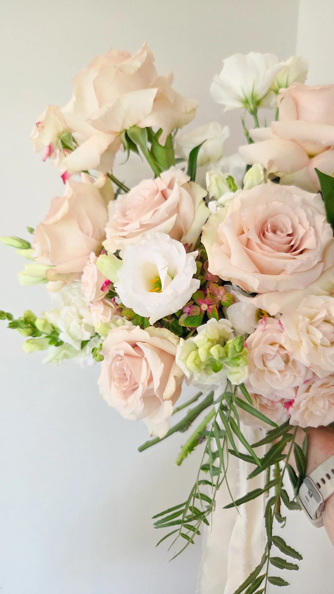 garden style wedding bouquet of quicksand roses, snapdragons, Lisianthus and hydrangeas